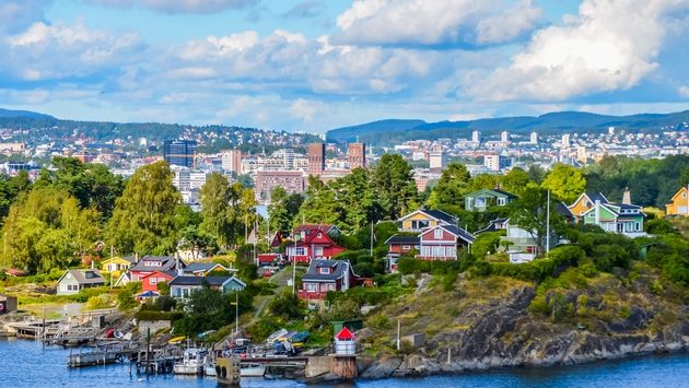 View of Oslo between city and typical nordic cottage (Damien VERRIER / iStock / Getty Images Plus)