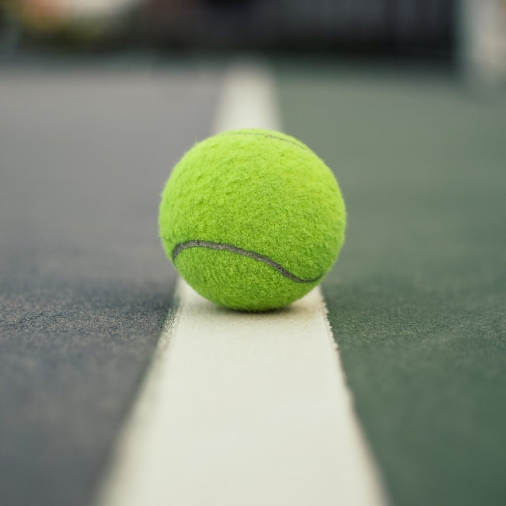 Green Tennis Ball on Court