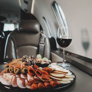 a plate of food and a glass of wine on a table