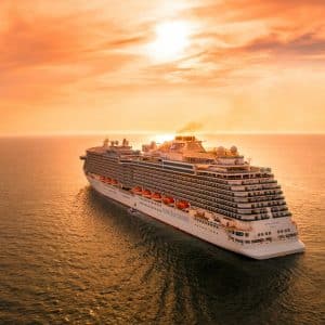 white ship on sea during sunset