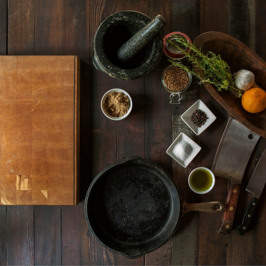 black mortar and pestle beside brown box in top view photography
