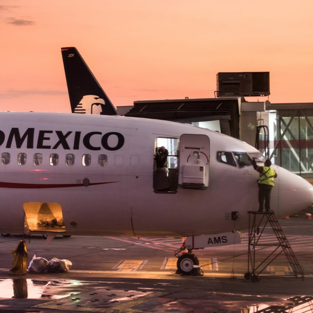 white and blue passenger plane on airport during daytime
