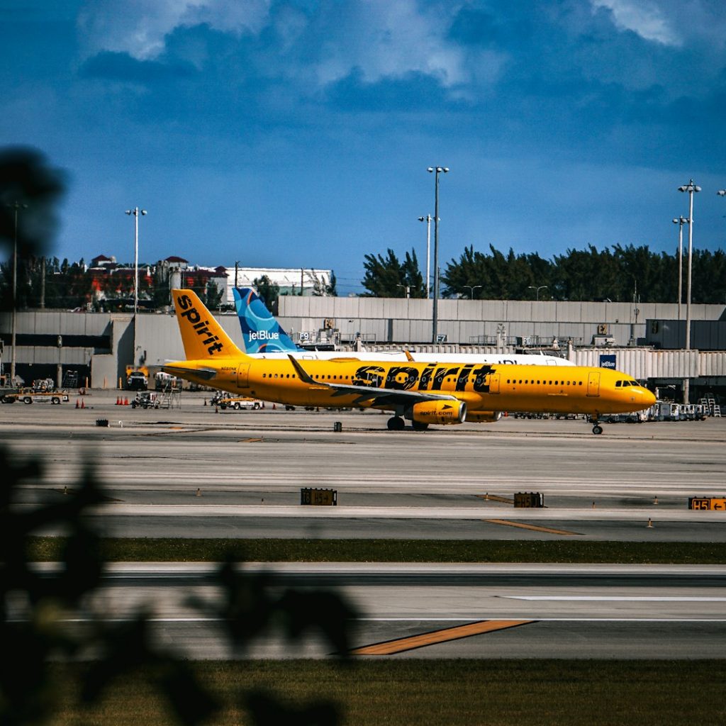 A yellow and blue plane is on the runway