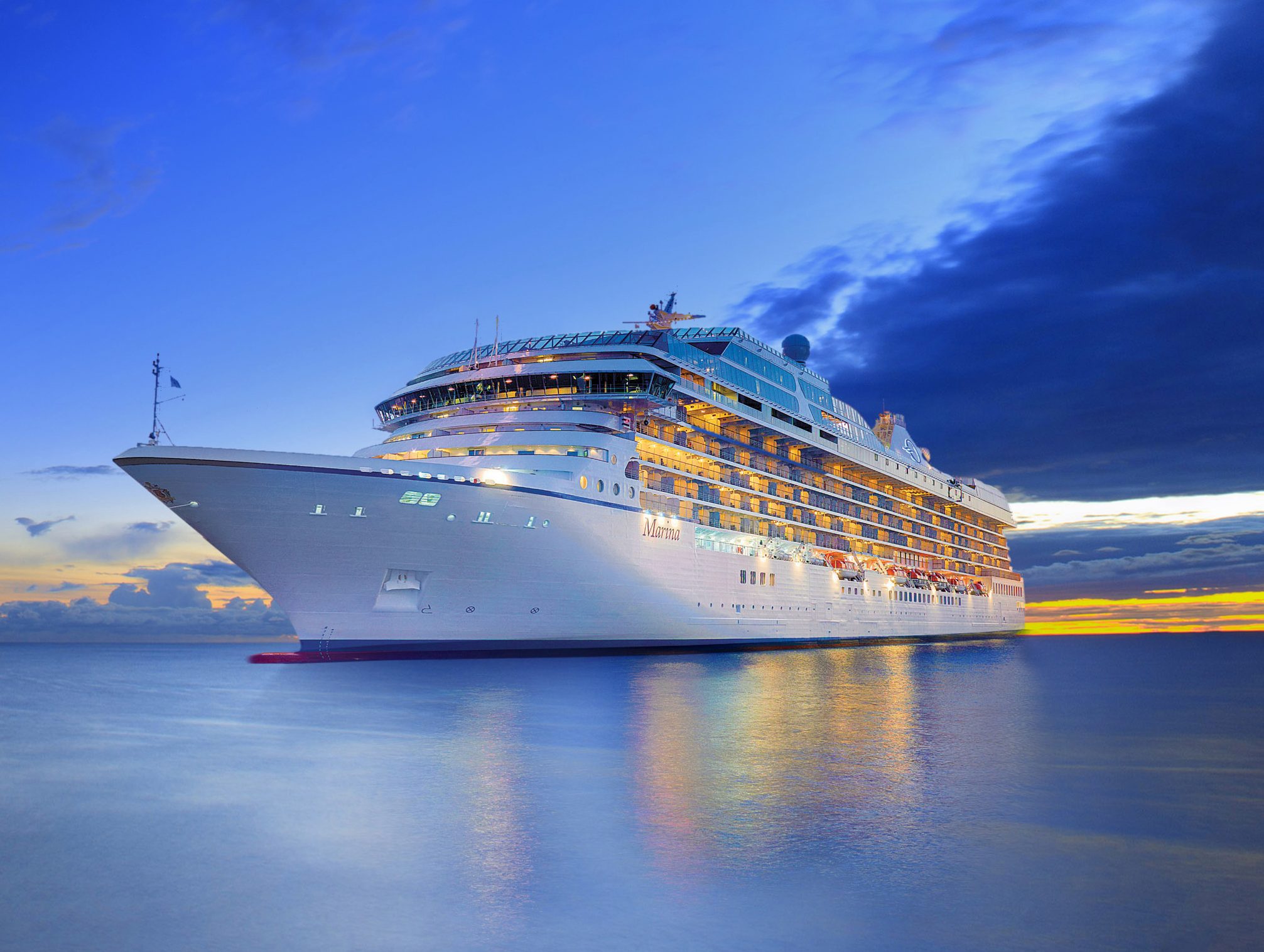 Cruise ship sailing beside a Mediterranean coast