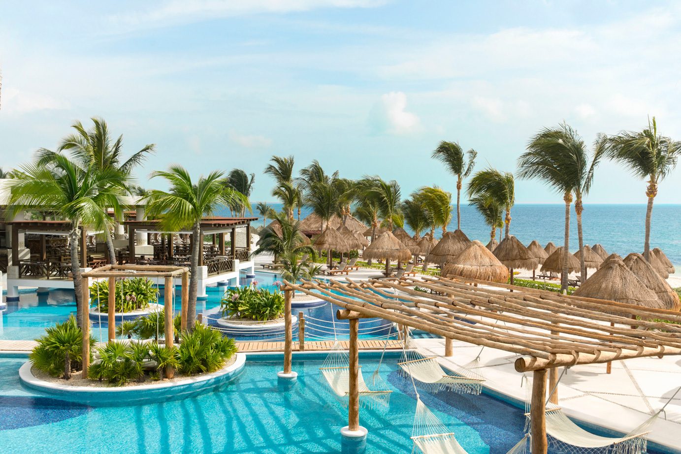 Sunlit pools, palm trees, and a Caribbean beach