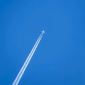 an airplane is flying high in the sky